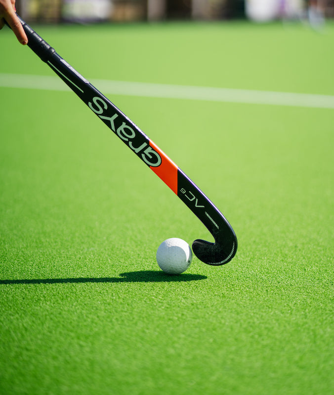 grays hockey stick and ball