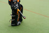 one sports warehouse obo hockey goalkeeper on hockey pitch